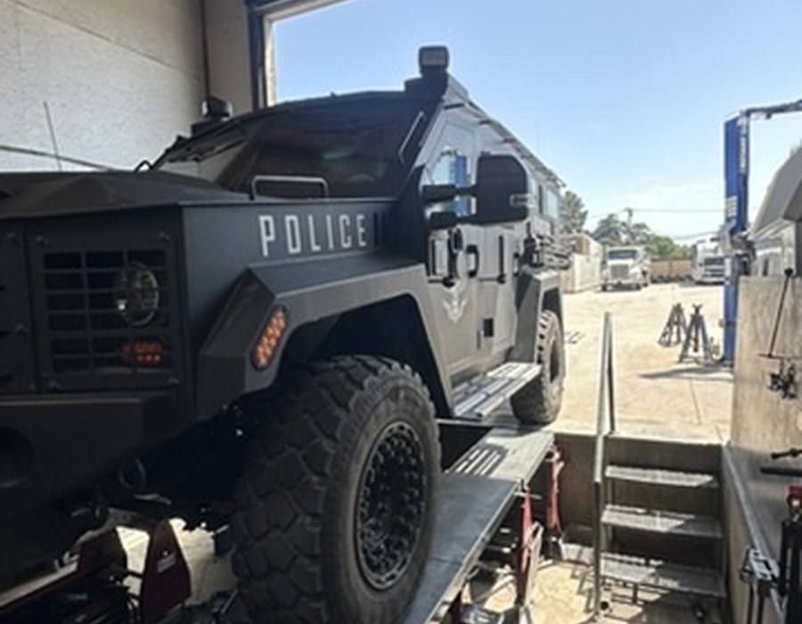 Armored police vehicle up on Pruett's alignment lift